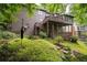 Multi-level deck and landscaped backyard of home featuring stone accents and mature trees at 5049 Lake Ter, Marietta, GA 30068