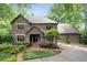 Brick home featuring a well-manicured lawn and a two-car garage at 5049 Lake Ter, Marietta, GA 30068