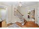 Foyer with hardwood floors, a staircase, and decorative wall paneling at 5049 Lake Ter, Marietta, GA 30068