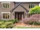 Charming brick home featuring a covered front entry, leaded glass windows and lush landscaping at 5049 Lake Ter, Marietta, GA 30068