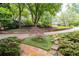 Beautifully landscaped front yard with a circular driveway, mature trees, and stone walkway at 5049 Lake Ter, Marietta, GA 30068