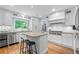Bright, white kitchen featuring an island, granite countertops, and stainless appliances at 5049 Lake Ter, Marietta, GA 30068