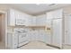 Kitchen featuring white cabinets, appliances, and plenty of storage space at 5049 Lake Ter, Marietta, GA 30068