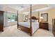 Spacious main bedroom with a four-poster bed, ceiling fan, and large windows at 5049 Lake Ter, Marietta, GA 30068