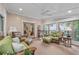 Bright and airy sun room with wooded views, wicker furnishings and comfortable seating arrangements at 5049 Lake Ter, Marietta, GA 30068