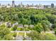 An aerial view of the neighborhood, showcasing mature trees and the city in the background at 711 Greenview Ne Ave, Atlanta, GA 30305