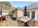 Outdoor deck featuring a wooden pergola over an outdoor dining set with seating for six and a grill at 711 Greenview Ne Ave, Atlanta, GA 30305