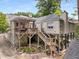Back of house featuring a large deck with pergola, outdoor space below, and mature landscaping at 711 Greenview Ne Ave, Atlanta, GA 30305
