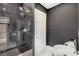 Modern bathroom showcasing a luxurious walk-in shower with striking black marble tile and stylish fixtures at 711 Greenview Ne Ave, Atlanta, GA 30305
