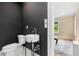 Stylish half bathroom featuring dark gray walls, white toilet and bowl sink at 711 Greenview Ne Ave, Atlanta, GA 30305