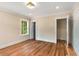 Bright bedroom featuring hardwood floors, neutral paint, a window, and white trim at 711 Greenview Ne Ave, Atlanta, GA 30305
