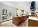 Spacious kitchen featuring a center island, modern appliances, and access to the outdoor patio at 711 Greenview Ne Ave, Atlanta, GA 30305