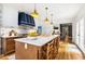 Bright eat-in kitchen with marble island, wood floors, custom cabinets, and modern appliances at 711 Greenview Ne Ave, Atlanta, GA 30305
