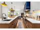 Modern kitchen featuring a large island, stainless steel appliances, and stylish lighting fixtures at 711 Greenview Ne Ave, Atlanta, GA 30305