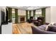 Elegant living room featuring a coffered ceiling, fireplace, hardwood floors, and refined furnishings at 711 Greenview Ne Ave, Atlanta, GA 30305