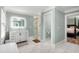 Bright ensuite bathroom features a double shower, and modern vanity with a lighted mirror at 711 Greenview Ne Ave, Atlanta, GA 30305