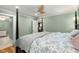 Spacious main bedroom showcasing tranquil green walls, neutral accents, and crown molding details at 711 Greenview Ne Ave, Atlanta, GA 30305
