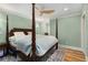 Airy main bedroom with designer ceiling fan, soft green walls, and elegant four poster bed at 711 Greenview Ne Ave, Atlanta, GA 30305