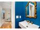Chic powder room with a modern sink, bright blue wall, and elegant gold-framed mirror at 711 Greenview Ne Ave, Atlanta, GA 30305