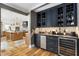 Chic wet bar featuring custom cabinetry, granite counters, and a wine fridge at 711 Greenview Ne Ave, Atlanta, GA 30305