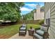 Outdoor patio seating area with lush green lawn and wooded perimeter at 812 Roget Way, Lawrenceville, GA 30045