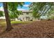 Spacious backyard featuring a well-maintained lawn and mature trees, perfect for outdoor relaxation at 812 Roget Way, Lawrenceville, GA 30045