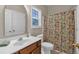 Bathroom featuring floral shower curtain, vanity with sink, and modern toilet at 812 Roget Way, Lawrenceville, GA 30045