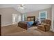 Spacious bedroom featuring carpet, a ceiling fan, and ample natural light from two windows at 812 Roget Way, Lawrenceville, GA 30045