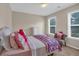 Bedroom with a comfortable bed, soft pillows, natural lighting, and a cozy sitting area at 812 Roget Way, Lawrenceville, GA 30045
