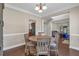 Open concept dining area with hardwood floors, a round table, and views of the living room at 812 Roget Way, Lawrenceville, GA 30045