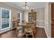 Elegant dining room featuring hardwood floors, a classic chandelier, and ample natural light at 812 Roget Way, Lawrenceville, GA 30045