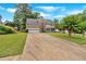 Long driveway leading to a traditional two-story home with well-kept lawn and landscaping at 812 Roget Way, Lawrenceville, GA 30045