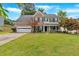 Charming two-story home featuring a manicured lawn and a welcoming front porch at 812 Roget Way, Lawrenceville, GA 30045
