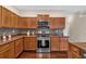 Well-equipped kitchen with stainless steel appliances, wood cabinets, and stylish backsplash at 812 Roget Way, Lawrenceville, GA 30045