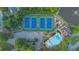Aerial view of community amenities including tennis courts, pool, clubhouse, parking, and lake at 1005 Cromwell Cv, Snellville, GA 30078