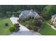 Stunning aerial view of home with lush landscaping, long driveway, and beautiful brick exterior at 1005 Cromwell Cv, Snellville, GA 30078