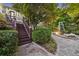 Beautiful landscaped backyard with stone pathway, deck with stairs and lush greenery at 1005 Cromwell Cv, Snellville, GA 30078