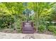 Picturesque backyard bridge with lush landscaping and stone pathway at 1005 Cromwell Cv, Snellville, GA 30078