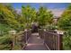 Backyard of home with stone pathway leading to an upper deck and garden at 1005 Cromwell Cv, Snellville, GA 30078