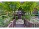 Stone path and steps lead to the backyard with serene and lush landscaping at 1005 Cromwell Cv, Snellville, GA 30078