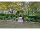 Serene backyard garden with stone pathway and pergola entrance at 1005 Cromwell Cv, Snellville, GA 30078