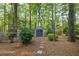 Backyard storage shed with double doors surrounded by trees and greenery, offering practical outdoor storage at 1005 Cromwell Cv, Snellville, GA 30078