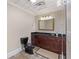Well-lit bathroom with a black toilet and dark wood vanity, offering modern comfort at 1005 Cromwell Cv, Snellville, GA 30078