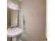Powder room featuring decorative mirror and pedestal sink at 1005 Cromwell Cv, Snellville, GA 30078