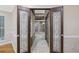 Ornate double doors open to a luxurious bathroom with multiple shower heads and tile flooring at 1005 Cromwell Cv, Snellville, GA 30078