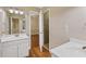 Bright bathroom featuring double vanity, and walk-in shower with tile and glass door at 1005 Cromwell Cv, Snellville, GA 30078