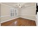 Bright bedroom with hardwood floors, shutters, and a ceiling fan at 1005 Cromwell Cv, Snellville, GA 30078