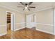 Neutral bedroom features wood floors, ceiling fan, and access to an ensuite bathroom at 1005 Cromwell Cv, Snellville, GA 30078