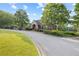 Community clubhouse with lush landscaping, featuring a covered entrance and ample parking, great for gatherings at 1005 Cromwell Cv, Snellville, GA 30078