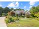 Beautifully landscaped brick home with lush lawn, mature trees, and a welcoming entrance at 1005 Cromwell Cv, Snellville, GA 30078
